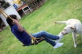 Child playing with beautiful puppy dog Ã¢â¬â¹Ã¢â¬â¹breed labrador in the garden Royalty Free Stock Photo